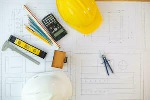 Building models and blueprints are placed on work desks in the construction engineering team offices to plan construction to achieve their goals and to simulate building models for clients to see. photo