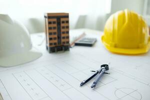 Building models and blueprints are placed on work desks in the construction engineering team offices to plan construction to achieve their goals and to simulate building models for clients to see. photo