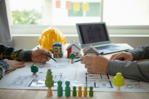 Construction engineers discuss and exchange ideas with architects to improve house plans to meet customer needs. A concept for exchange of design ideas between construction engineers and architects. photo