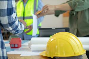 Yellow safety helmet were prepared for workers to wear before entering the construction area to prevent the danger of falling objects from working. Yellow safety helmet is placed on a wooden table. photo