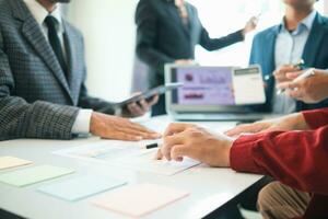 group businessmen and investors met together in conference room to view annual results their investments in business together in order to plan marketing doing business that would produce better result photo