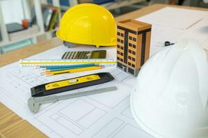 Building models and blueprints are placed on work desks in the construction engineering team offices to plan construction to achieve their goals and to simulate building models for clients to see. photo