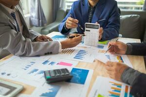 group businessmen and investors met together in conference room to view annual results their investments in business together in order to plan marketing doing business that would produce better result photo