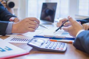 group businessmen and investors met together in conference room to view annual results their investments in business together in order to plan marketing doing business that would produce better result photo