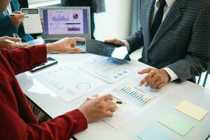 group businessmen and investors met together in conference room to view annual results their investments in business together in order to plan marketing doing business that would produce better result photo