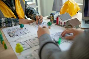 Construction engineers discuss and exchange ideas with architects to improve house plans to meet customer needs. A concept for exchange of design ideas between construction engineers and architects. photo
