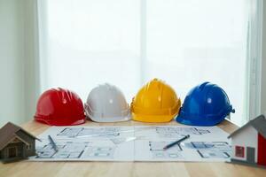 Yellow helmet were prepared for Construction engineers to wear before entering the construction area to prevent danger of falling objects from working. Yellow safety helmet is placed on white table. photo