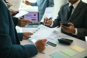 group businessmen and investors met together in conference room to view annual results their investments in business together in order to plan marketing doing business that would produce better result photo