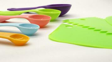 Measuring spoons in various colors and cake dough cutting tool photo