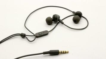 Close up of black wired earphones photo