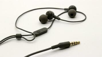 Close up of black wired earphones photo