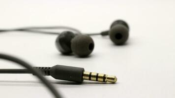 Close up of black wired earphones photo