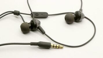 Close up of black wired earphones photo