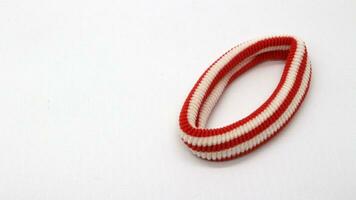 Red cloth hair tie isolated photo