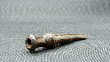 Indonesian wooden pipe for smoking photo