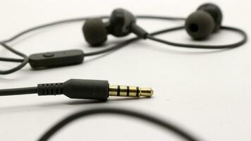 Close up of black wired earphones photo