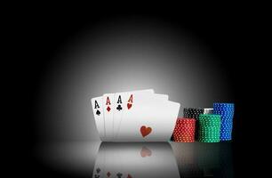 Four aces standing on a mirror surface with a backlight, ahead of a colorful chips in piles. Black background. Gambling entertainment. Close-up. photo