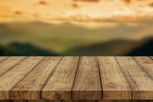 Empty wood floor for display, advertise, and promote montage product with mountain background, and silhouette. photo