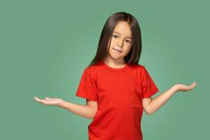 Surprised girl with spread arms isolated on green background photo