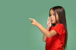 Young girl in red t-shirt is afraid of something photo