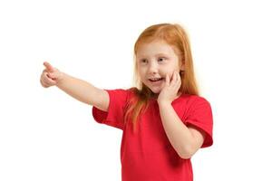 Education, school and imaginary screen concept - cute little girl pointing in the air or imaginary screen photo