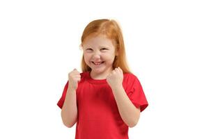 Cheerful little girl, look so excited she is raising her fists up, isolated on white background. photo