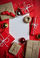 Christmas gift box composition on a red background. Flat lay top view copy space photo