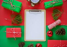 Christmas gift box composition on a red and green background. Flat lay top view copy space photo