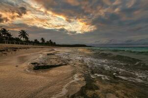 An incredible feeling at the shore of the Atlantic ocean in anticipation of sunset, Cuba photo