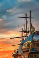 A part of the old colorful ship at sunset. Vertical view photo