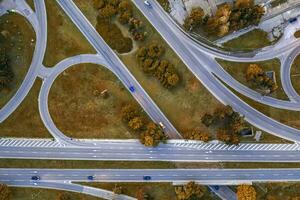 Aerial top view of the modern highway road intersection in autumn. Drone photography. photo