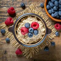 AI generated Dry rolled oatmeal with berries and fruits in bowl isolated on white background. photo