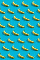 Colorful pattern of bananas on sky blue background. photo