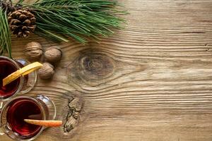 Mulled wine with spices on wooden background photo