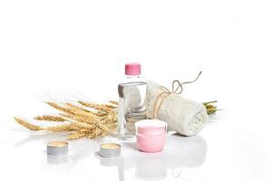 Herbal and mineral skincare. Jar of cream, oil with wheat, cosmetic bottles. Without label photo
