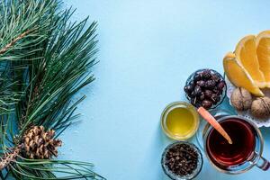 Mulled wine with spices on blue background photo