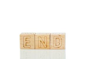 Wooden cubes with letters end on a white background photo