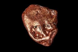 Macro mineral stone of a copper nugget on a microcline on a black background photo