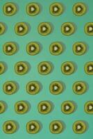 Pattern of kiwi. Top view of the sliced kiwi on blue background. Minimal flat lay concept. photo