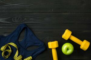 Sports equipment and wear on dark wooden background, top view photo