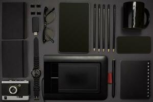 Black objects from the office on a dark gray background. Work an photo