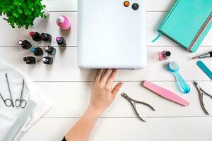 Manicure set and nail polish on wooden background photo