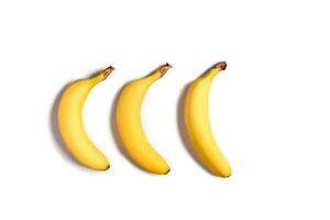 Ripe yellow bananas on a white background photo