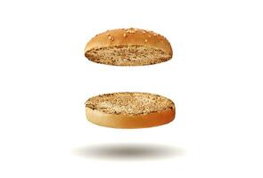 Flying, baked or grilled, cut in half burger bun sprinkled with sesame seeds. Isolated on white. Cooking and fast food. Close-up, copy space photo