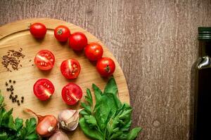 Fresh organic ingredients for salad making spinach, tomatoes, sprouts, basil, olive oil on rustic background, top view. photo