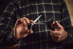 Barber is holding scissors and razor in his hands barbershop. photo