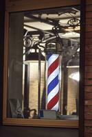 The famous symbol of a barber shop with it swirling red, blue and white stripes. photo