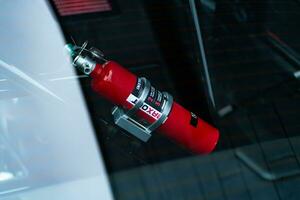 a red fire extinguisher is seen in the window of a car photo