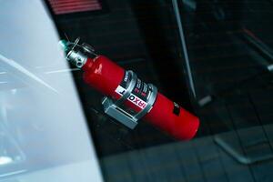 a red fire extinguisher is seen in the window of a car photo