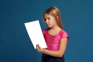 Portrait of adorable emotional little girl on blue background photo